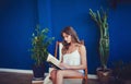 Beautiful girl with long hair reads a book Royalty Free Stock Photo