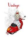 Beautiful girl with long hair in a summer dress sits on a vintage moped. Fashion and style, clothes and accessories. Royalty Free Stock Photo