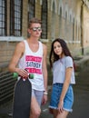 An appealing girl dating with a fellow, walking outdoor on nature on a natural blurred background.