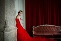 Beautiful girl in long red dress and in royal crown Royalty Free Stock Photo