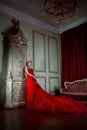 Beautiful girl in long red dress and in royal crown Royalty Free Stock Photo