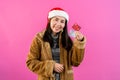 Beautiful girl in long-sleeved shirt and a Christmas hat. In hand credit card Shown for online purchases this Christmas season Royalty Free Stock Photo