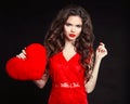 Beautiful girl with long wavy hair in red dress holding valentin Royalty Free Stock Photo