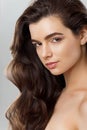 Beautiful girl with long wavy and shiny hair . Brunette woman with curly hairstyle Royalty Free Stock Photo