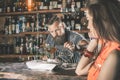 Beautiful girl looking at handsome bartender