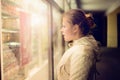 Beautiful girl looking in the shopwindow on the night. Royalty Free Stock Photo