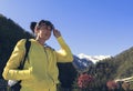 A beautiful girl looks into the distance with enthusiasm against the background of a mountain landscape