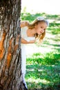 Beautiful Girl Looks From The Tree In The Park