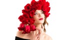 Beautiful girl with luxurious hairstyle of red roses Royalty Free Stock Photo