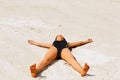 Beautiful girl lying on the beach in the shape of stars Royalty Free Stock Photo