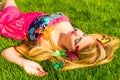 Beautiful girl lying on a grass in park