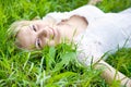 Beautiful girl is lying on green grass Royalty Free Stock Photo