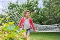 Beautiful girl lying on hammock, smiling resting child in spring garden Royalty Free Stock Photo