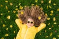 Beautiful girl lying on lawn with yellow leaves in autumn park Royalty Free Stock Photo