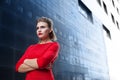 Beautiful girl with make-up in a red dress in a modern city Royalty Free Stock Photo