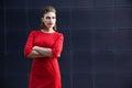 Beautiful girl with make-up in a red dress in a modern city Royalty Free Stock Photo