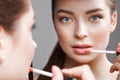 Beautiful girl makes herself a make-up in the mirror. Beauty face. Royalty Free Stock Photo