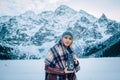 Beautiful girl makes a photo on an old vintage camera. In the mountains in winter, adventure and travel Royalty Free Stock Photo