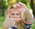 Beautiful girl making frame with hands while outdoors Royalty Free Stock Photo