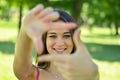 Beautiful girl making frame with hands while outdoors Royalty Free Stock Photo