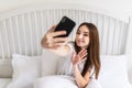 Beautiful girl making selfie in the bed at home Royalty Free Stock Photo