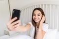 Beautiful girl making selfie in the bed at home Royalty Free Stock Photo