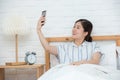 Beautiful girl making selfie in the bed. Beautiful girl making self on the bed at home. Selfie in the morning Royalty Free Stock Photo