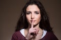 Beautiful girl making silence gesture