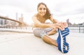 Beautiful girl making stretching before intense running in New york city