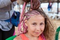 Beautiful girl making trendy braids dreadlocks. Afro American female hand at work