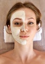 Beautiful girl with mask from clay on his face. Cosmetic mask. Beauty wellness concept Royalty Free Stock Photo