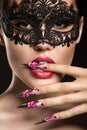 Beautiful girl in mask with long nails and sensual Royalty Free Stock Photo