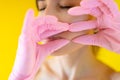 Beautiful girl massaging her face wearing pink gloves Royalty Free Stock Photo