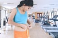 Beautiful girl measuring her waist in gym center Royalty Free Stock Photo