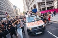 Beautiful girl with megaphone sitting on the top of the van in front of the Huge crowd of Black Lives Matters protesters heading