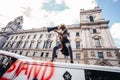 Beautiful girl with megaphone standing on the top of the van in front of the Huge crowd of Black Lives Matters protesters heading