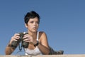 Beautiful girl in military clothes and binoculars