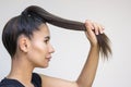 Beautiful girl model with shiny brown straight long hair. Hair care products. Keeps hair in a fist Royalty Free Stock Photo