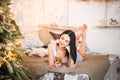 Beautiful girl in the morning with a cup in the New Year`s interior. Woman at home at Christmas time in a bedroom in a rustic styl Royalty Free Stock Photo