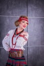 A beautiful girl in National Ukrainian Costume. captured in studio. Embroidery and jacket. wreath. circlet of flowers. red lips Royalty Free Stock Photo