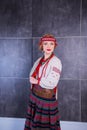 A beautiful girl in National Ukrainian Costume. captured in studio. Embroidery and jacket. wreath. circlet of flowers. red lips Royalty Free Stock Photo