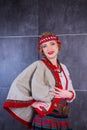 A beautiful girl in National Ukrainian Costume. captured in studio. Embroidery and jacket. wreath. circlet of flowers. red lips Royalty Free Stock Photo