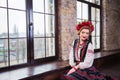 A beautiful girl in National Ukrainian Costume. captured in studio. Embroidery and jacket. wreath. circlet of flowers. red lips Royalty Free Stock Photo