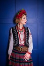 A beautiful girl in National Ukrainian Costume. captured in studio. Embroidery and jacket. wreath. circlet of flowers. red lips Royalty Free Stock Photo