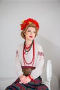 A beautiful girl in National Ukrainian Costume. captured in studio. Embroidery and jacket. wreath. circlet of flowers. red lips Royalty Free Stock Photo