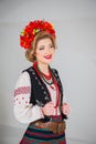 A beautiful girl in National Ukrainian Costume. captured in studio. Embroidery and jacket. wreath. circlet of flowers. red lips Royalty Free Stock Photo