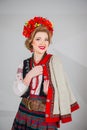 A beautiful girl in National Ukrainian Costume. captured in studio. Embroidery and jacket. wreath. circlet of flowers. red lips Royalty Free Stock Photo