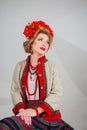 A beautiful girl in National Ukrainian Costume. captured in studio. Embroidery and jacket. wreath. circlet of flowers. red lips Royalty Free Stock Photo