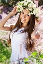 Beautiful girl on the nature in wreath of flowers