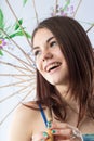 Beautiful girl nicely smiling with a blue Eastern parasol